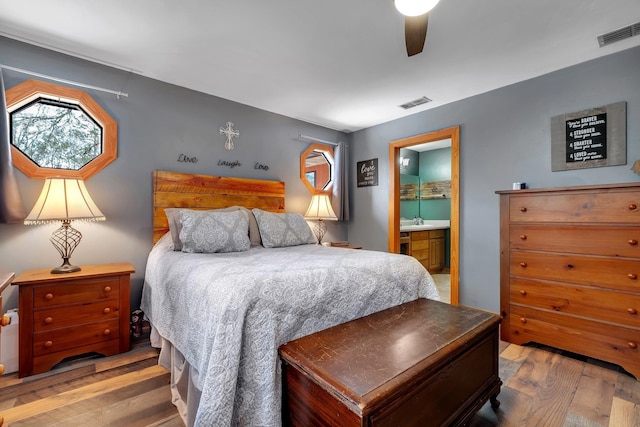 bedroom featuring ceiling fan, connected bathroom, and light hardwood / wood-style floors