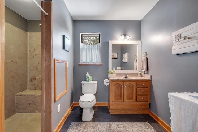 bathroom with walk in shower, vanity, and toilet