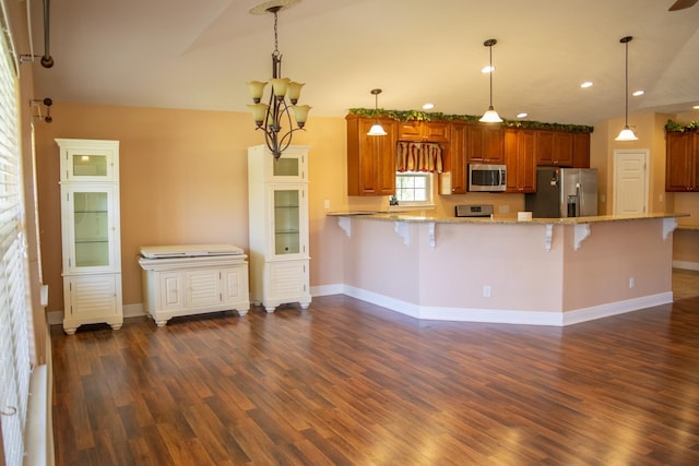 21 Blenheim Rd Fl, Shalimar, FL 32579 - kitchen featuring kitchen peninsula, light stone counters, a breakfast bar, stainless steel appliances, and pendant lighting