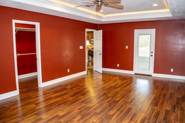 21 Blenheim Rd Fl, Shalimar, FL 32579 - empty room with dark hardwood / wood-style floors, ceiling fan, a raised ceiling, and ornamental molding
