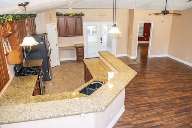 21 Blenheim Rd Fl, Shalimar, FL 32579 - kitchen with french doors, sink, decorative light fixtures, light stone counters, and stainless steel range with gas stovetop