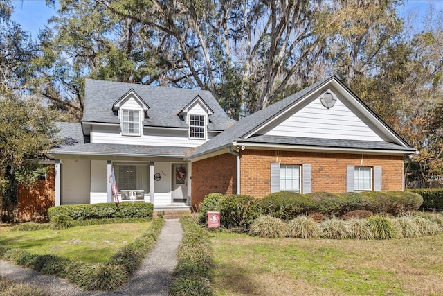 view of front of home with a porch and a front lawn