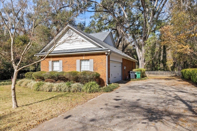 view of side of property featuring a garage and cooling unit