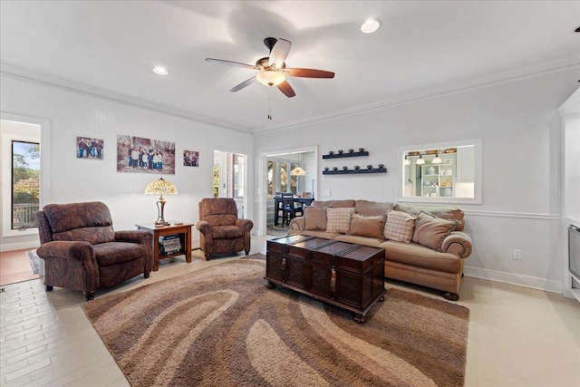 living room with crown molding and ceiling fan