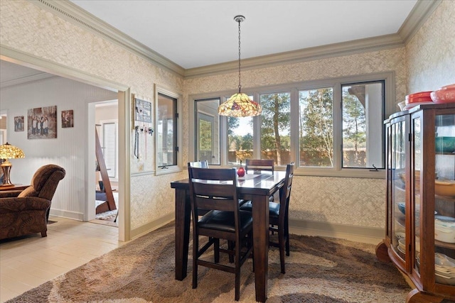 tiled dining space featuring crown molding