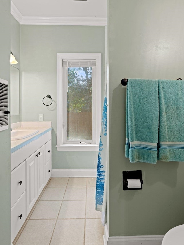 bathroom with crown molding, vanity, and tile patterned floors