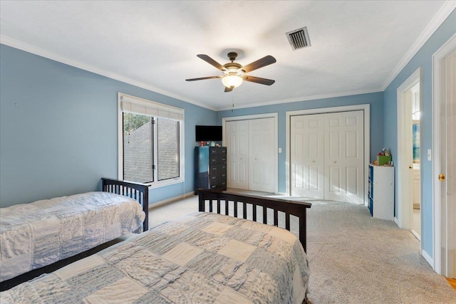 bedroom with multiple closets, ceiling fan, ornamental molding, and light carpet