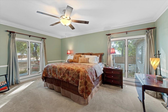 carpeted bedroom with multiple windows, crown molding, and access to outside