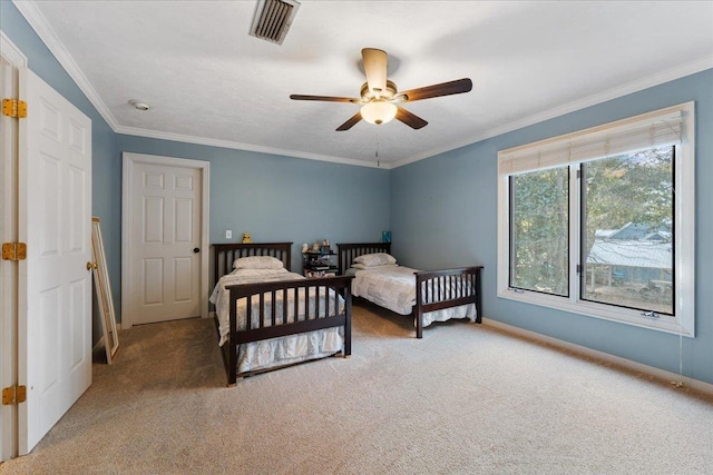 bedroom with ornamental molding, carpet floors, and ceiling fan