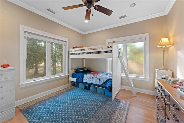 bedroom with multiple windows, ornamental molding, and light hardwood / wood-style flooring