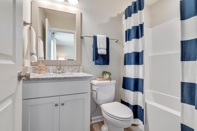 full bathroom with vanity, toilet, and shower / bath combo with shower curtain