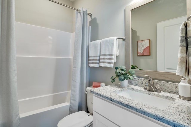 full bathroom with vanity, shower / tub combo with curtain, and toilet