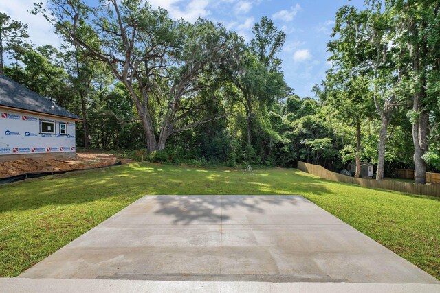 view of yard featuring fence and a patio