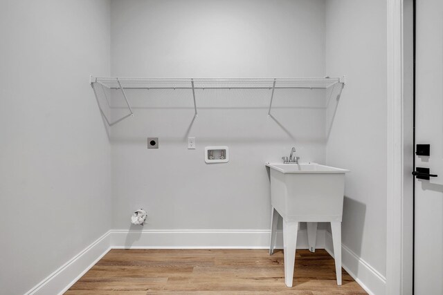 laundry area with hookup for an electric dryer, laundry area, washer hookup, and light wood finished floors