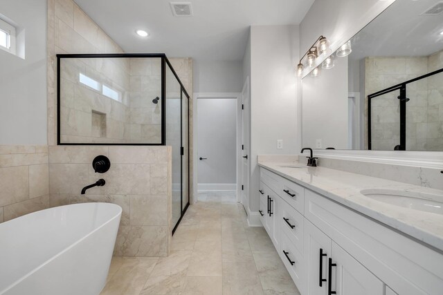 full bath with a sink, a shower stall, and visible vents