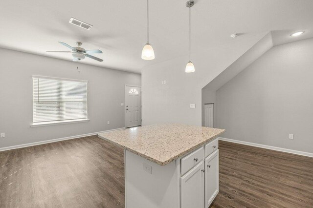 kitchen featuring white cabinetry, ceiling fan, decorative light fixtures, a center island, and dark hardwood / wood-style flooring