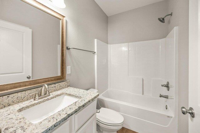 full bathroom with vanity, toilet, and bathtub / shower combination