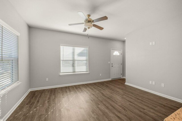 spare room featuring dark hardwood / wood-style flooring and ceiling fan