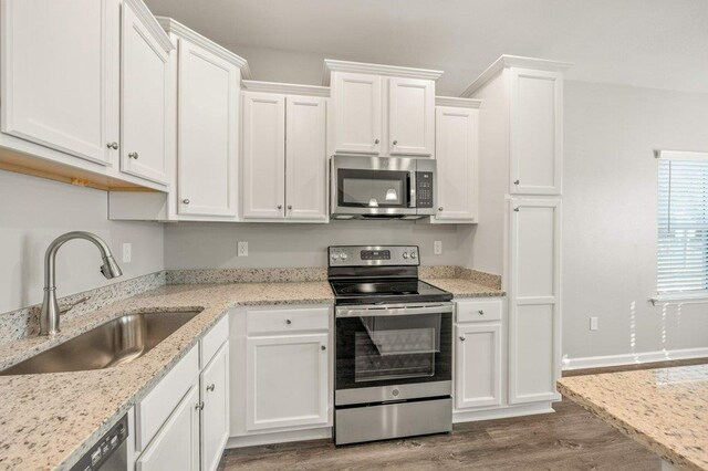 kitchen with white cabinets, sink, dark hardwood / wood-style floors, and stainless steel appliances