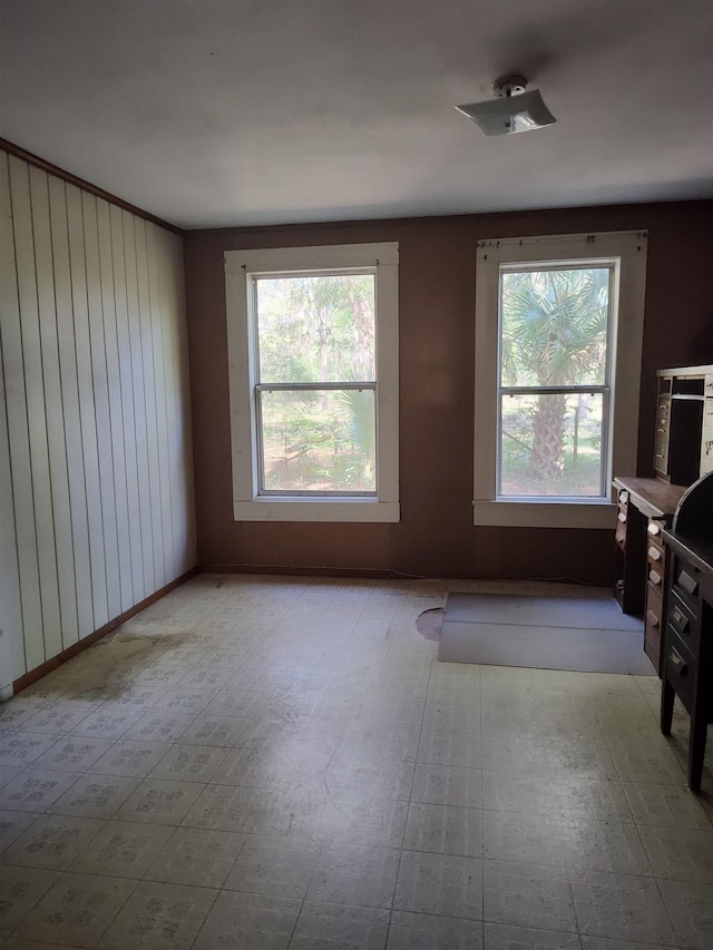 empty room featuring wood walls