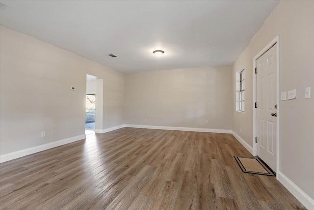 spare room with hardwood / wood-style flooring