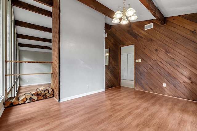 3508 Willow Springs Ln, Tallahassee, FL 32312 - empty room with beam ceiling, a chandelier, wood walls, and wood finished floors
