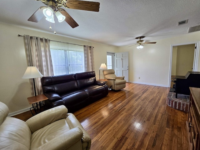 2612 W Tharpe St, Tallahassee, FL 32303 - living room featuring a ceiling fan, wood finished floors, a wood stove, and a textured ceiling