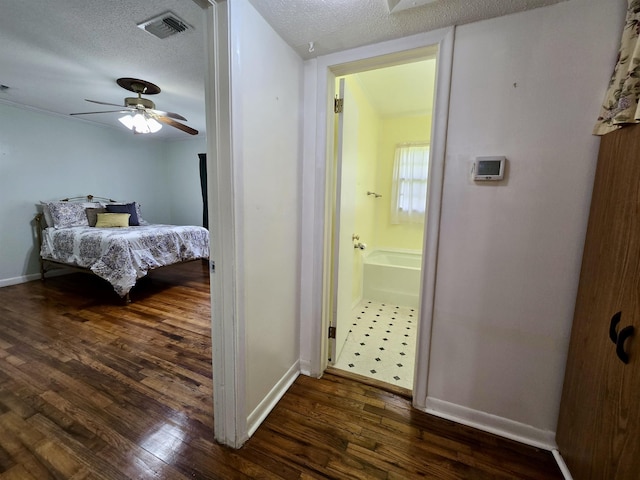 2612 W Tharpe St, Tallahassee, FL 32303 - bedroom featuring dark wood-style flooring, a textured ceiling, ensuite bathroom, and ceiling fan