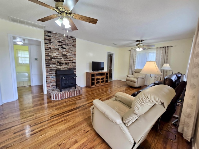 2612 W Tharpe St, Tallahassee, FL 32303 - living room featuring a wood stove, plenty of natural light, and a ceiling fan