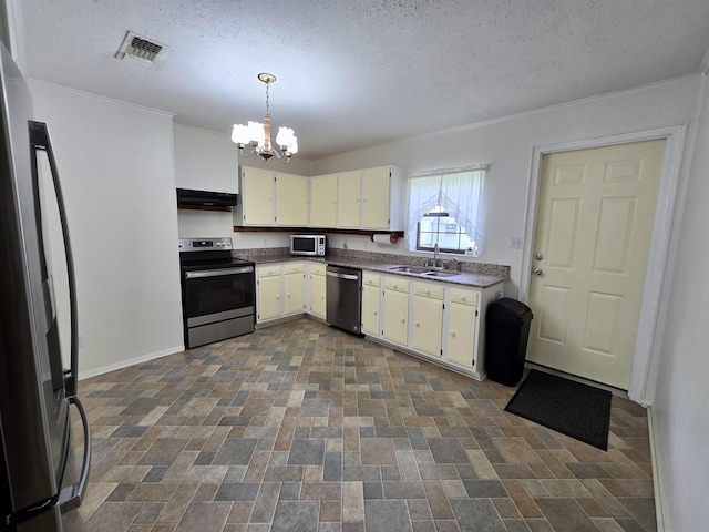 2612 W Tharpe St, Tallahassee, FL 32303 - kitchen with appliances with stainless steel finishes, a chandelier, ventilation hood, dark countertops, and hanging light fixtures