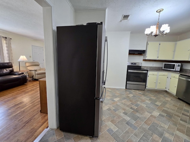 2612 W Tharpe St, Tallahassee, FL 32303 - kitchen featuring appliances with stainless steel finishes, extractor fan, a textured ceiling, a chandelier, and pendant lighting