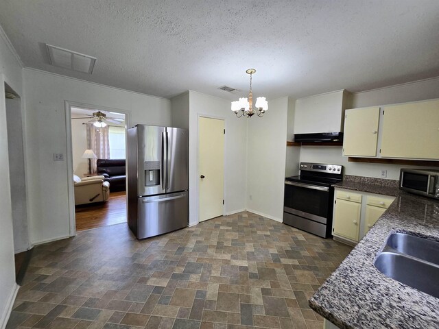 2612 W Tharpe St, Tallahassee, FL 32303 - kitchen with appliances with stainless steel finishes, under cabinet range hood, stone finish floors, a textured ceiling, and a chandelier