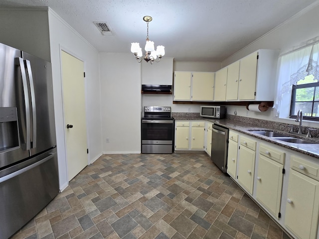 2612 W Tharpe St, Tallahassee, FL 32303 - kitchen featuring appliances with stainless steel finishes, a chandelier, crown molding, ventilation hood, and dark countertops