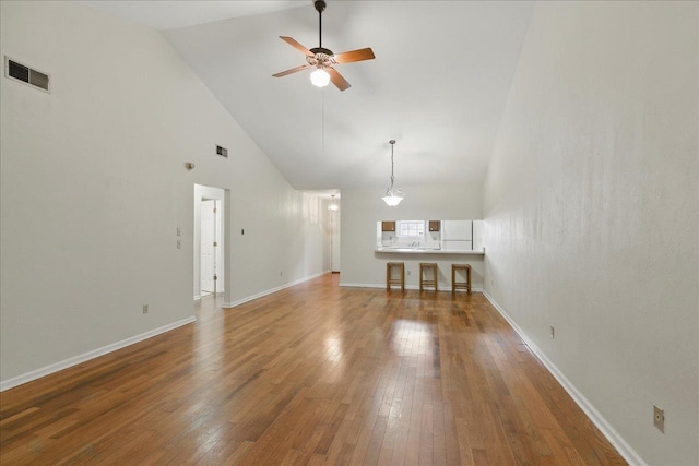 817 Jamestown Ct, Tallahassee, FL 32308 - unfurnished living room with high vaulted ceiling, a ceiling fan, hardwood / wood-style flooring, and baseboards
