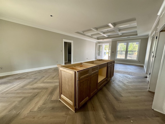 kitchen with ornamental molding, open floor plan, coffered ceiling, and baseboards