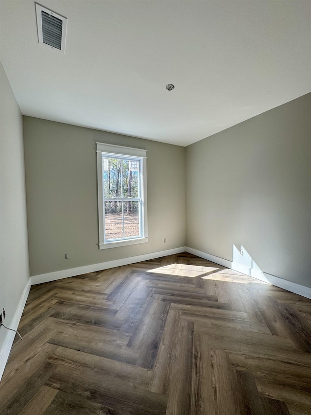 empty room featuring baseboards and visible vents