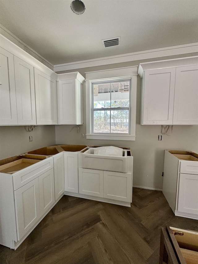 kitchen with visible vents and white cabinetry