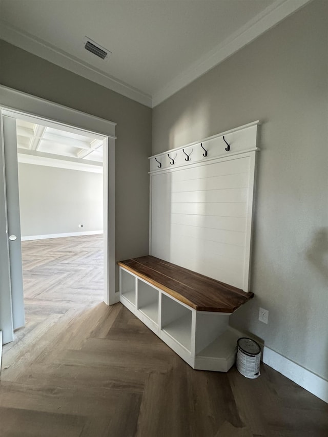 mudroom featuring ornamental molding, visible vents, and baseboards