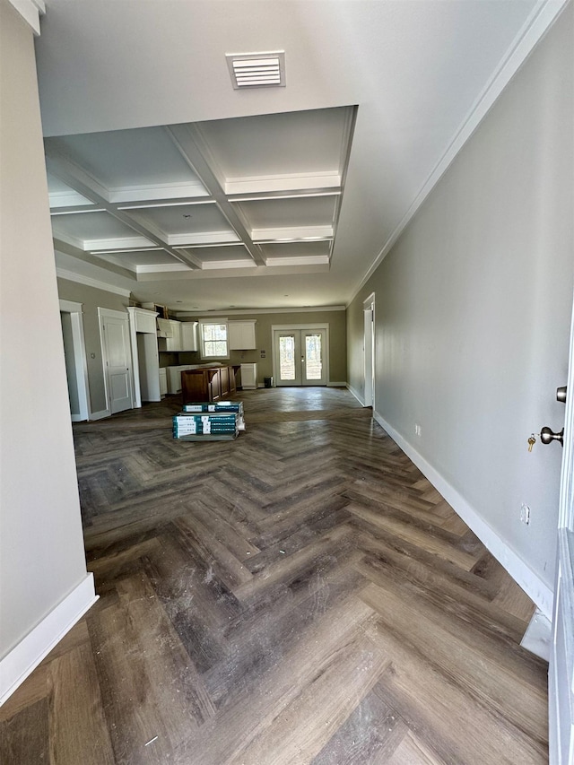 unfurnished living room with french doors, coffered ceiling, visible vents, and baseboards