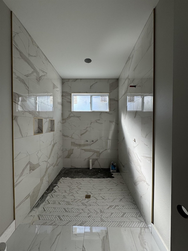 bathroom featuring marble finish floor and a marble finish shower