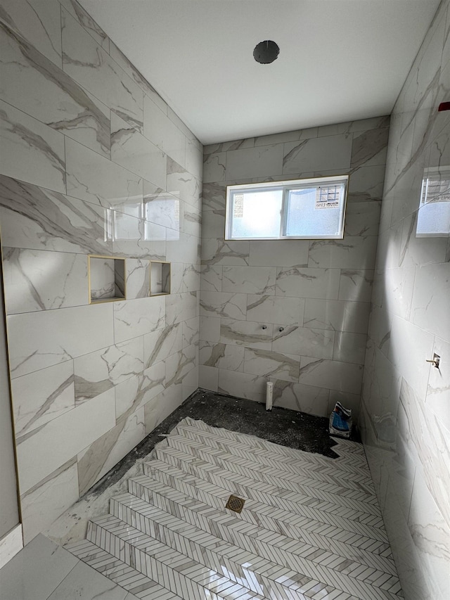 bathroom with a tile shower