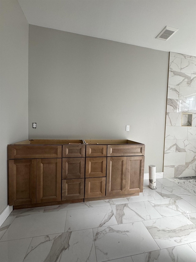 bathroom with marble finish floor and visible vents