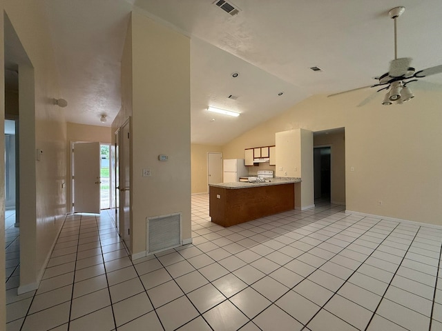 kitchen with white appliances, vaulted ceiling, ceiling fan, light tile patterned floors, and kitchen peninsula