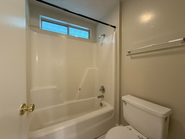 bathroom featuring shower / bathing tub combination and toilet