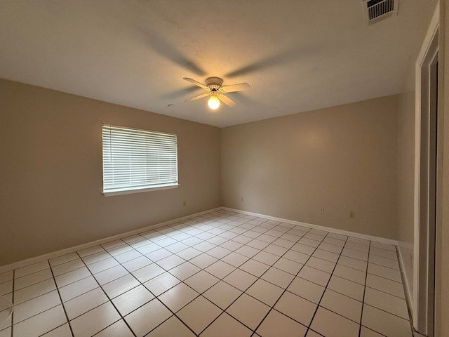 tiled empty room featuring ceiling fan