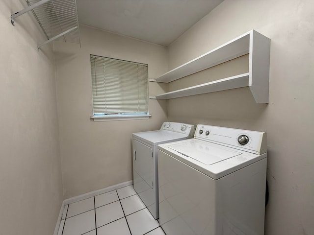 laundry area with washer and dryer and light tile patterned flooring