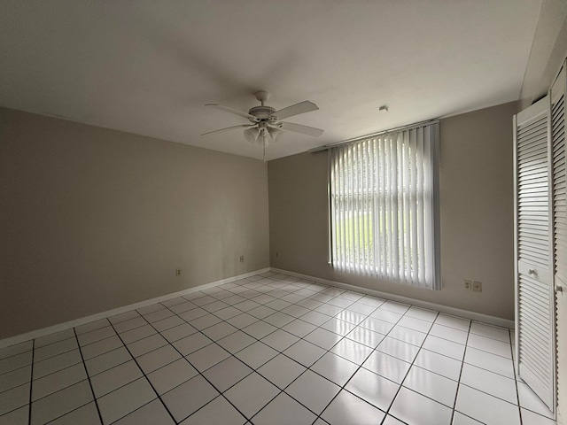 unfurnished room featuring light tile patterned floors and ceiling fan