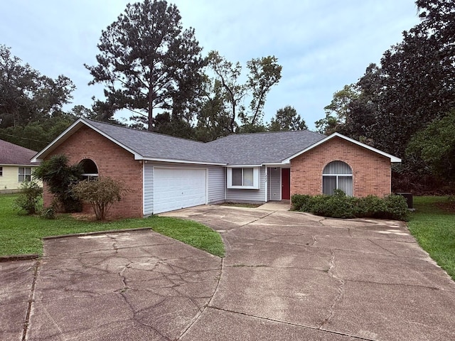 single story home with a front yard and a garage