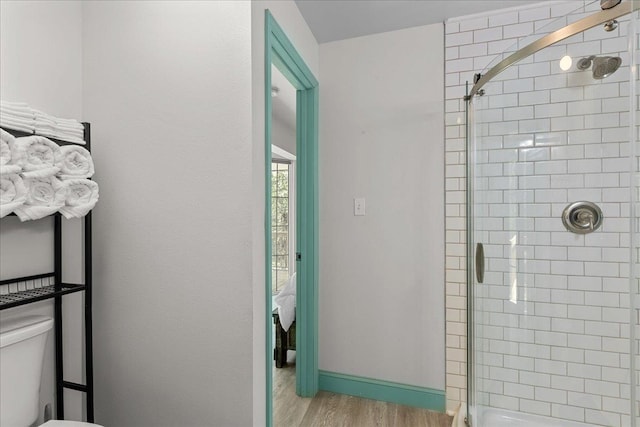 1334 Jr Howell Rd, Steinhatchee, FL 32359 - bathroom with toilet, baseboards, wood finished floors, and tiled shower