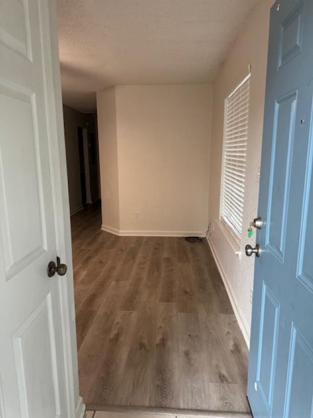 corridor with hardwood / wood-style floors